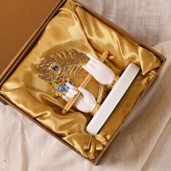 White & Golden Polyresin Gold Plated Krishna Hand With Face, Flute And Peacock Feather